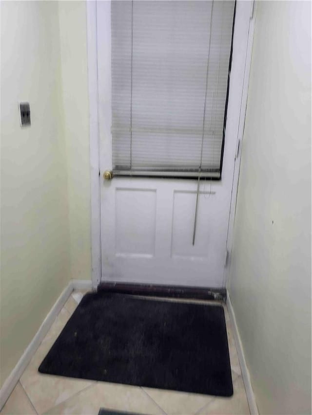 doorway to outside featuring light tile patterned flooring