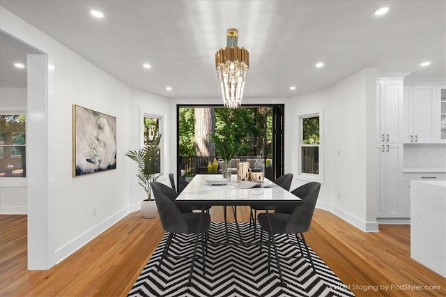 dining room featuring light hardwood / wood-style flooring and a chandelier