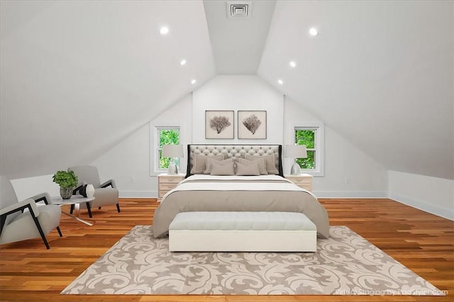 bedroom with hardwood / wood-style flooring, vaulted ceiling, and multiple windows