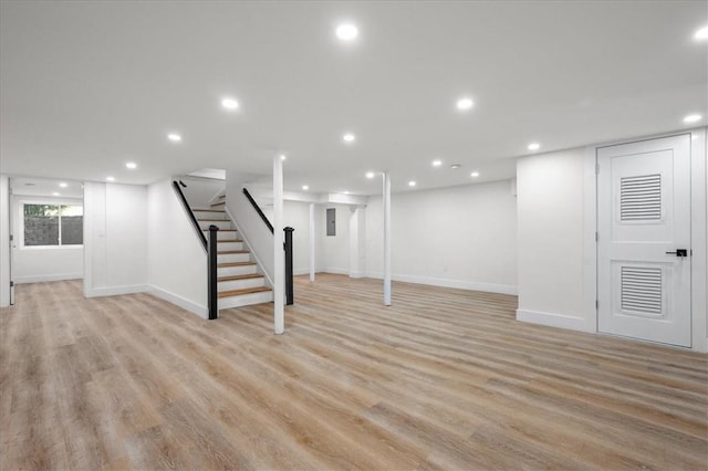 basement with light hardwood / wood-style flooring