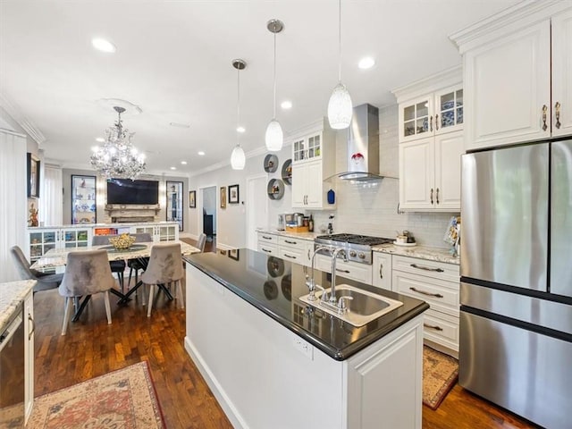 kitchen featuring dark hardwood / wood-style flooring, wall chimney exhaust hood, stainless steel appliances, sink, and white cabinetry