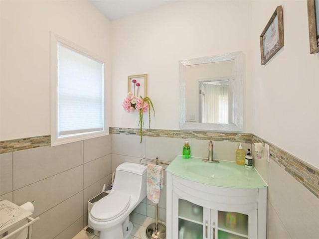 bathroom featuring tile patterned flooring, toilet, and tile walls