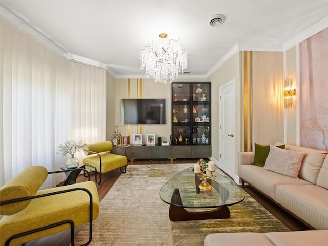 living room with crown molding, hardwood / wood-style floors, and a chandelier