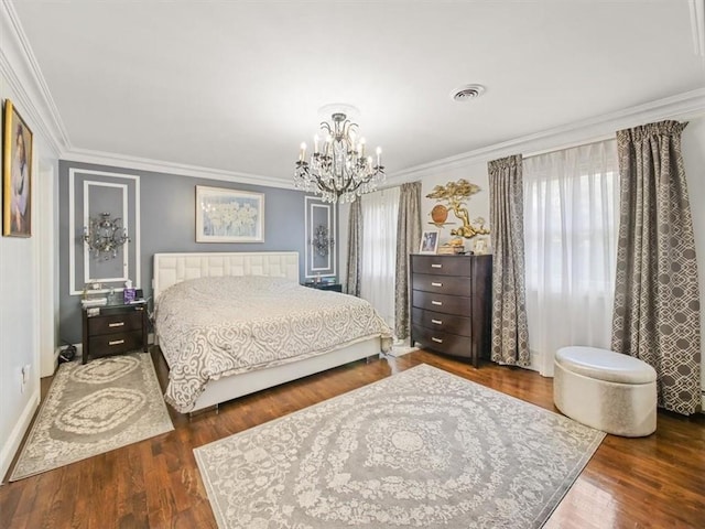 bedroom with dark hardwood / wood-style floors, ornamental molding, and a notable chandelier