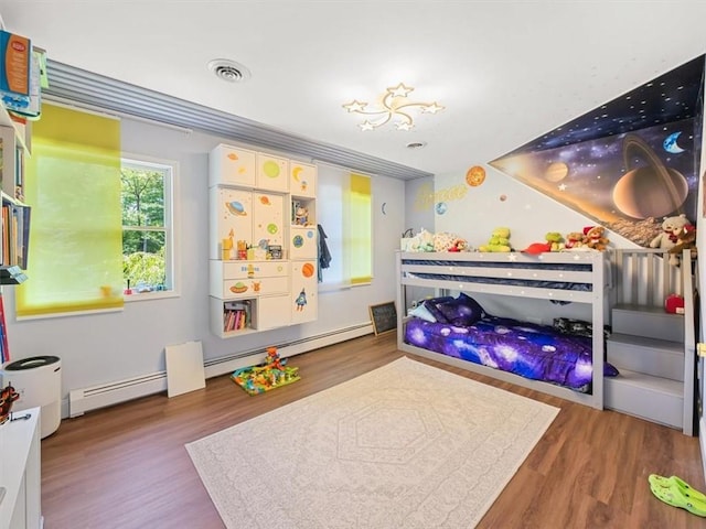 bedroom featuring hardwood / wood-style floors and a baseboard radiator