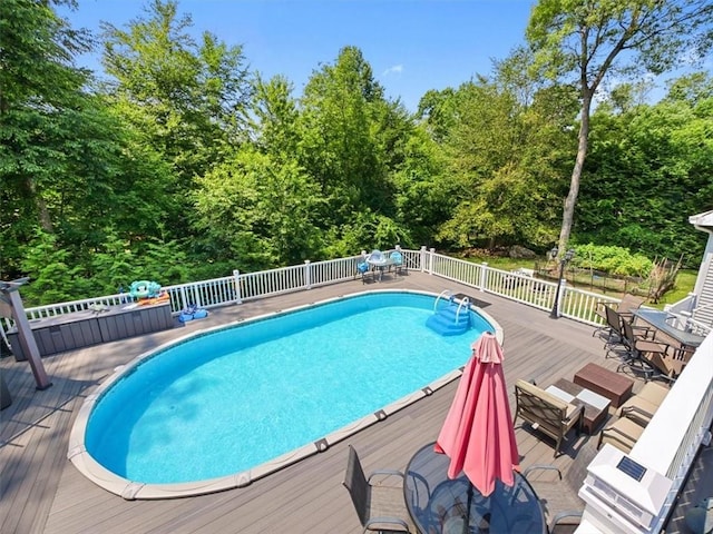 view of swimming pool with a deck