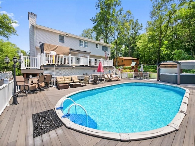 view of pool featuring an outdoor hangout area and a wooden deck