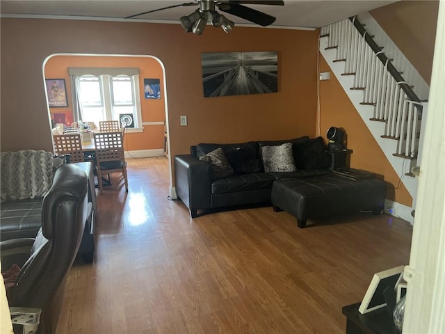 living room featuring ceiling fan, hardwood / wood-style floors, and crown molding