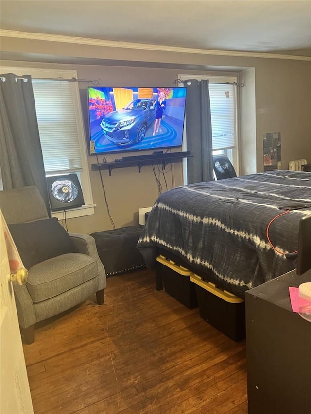 bedroom featuring hardwood / wood-style flooring and crown molding