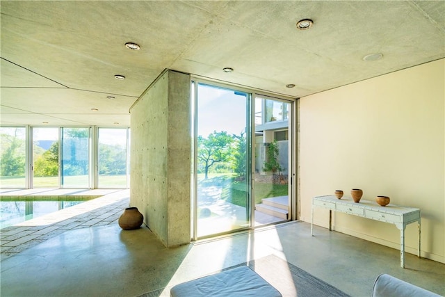 doorway with a wealth of natural light and concrete flooring