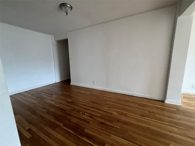 spare room featuring dark wood-type flooring