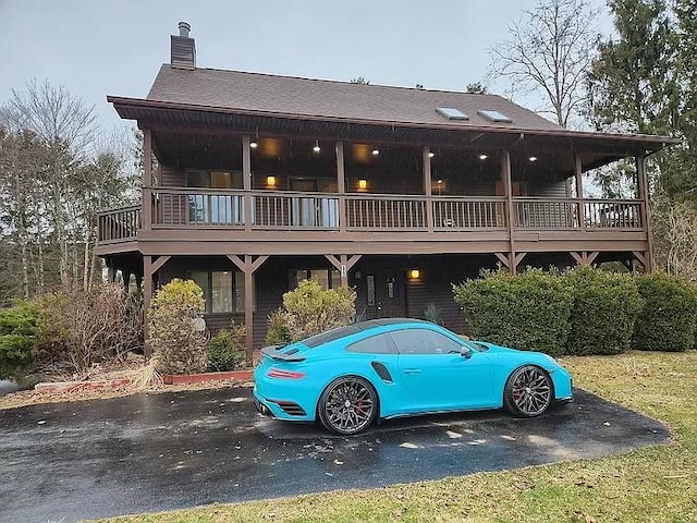 rear view of house with a wooden deck