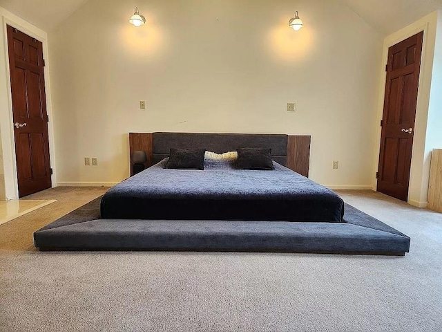 carpeted bedroom featuring vaulted ceiling