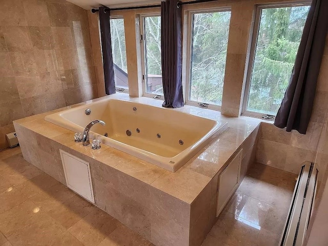 bathroom with tiled bath and tile walls