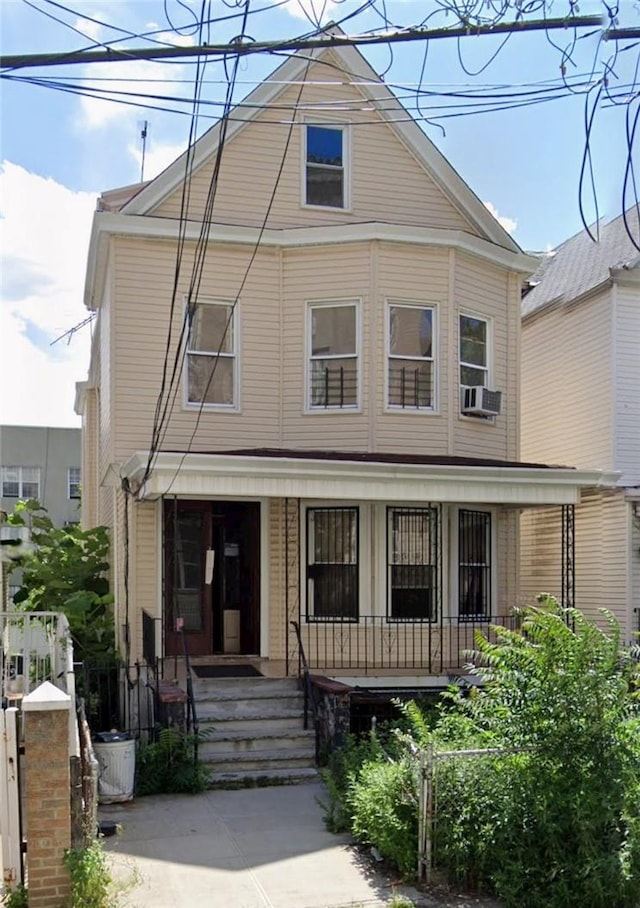 view of front of house featuring cooling unit and covered porch