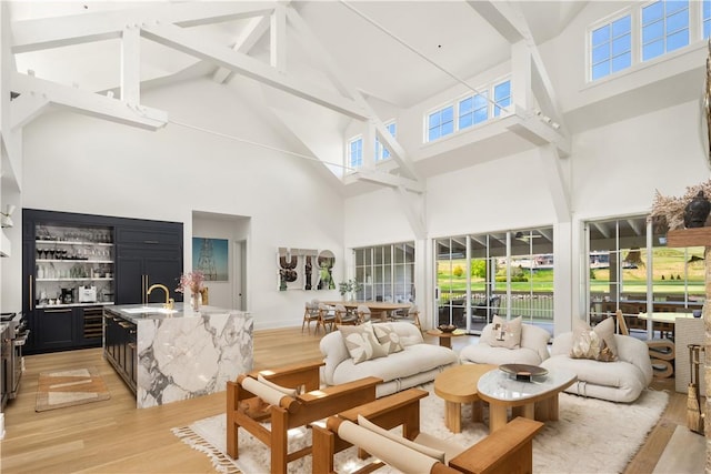 sunroom / solarium with vaulted ceiling with beams, indoor wet bar, and a wealth of natural light