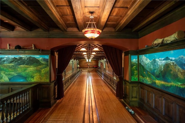 game room featuring beam ceiling, bowling, wood-type flooring, and wooden ceiling