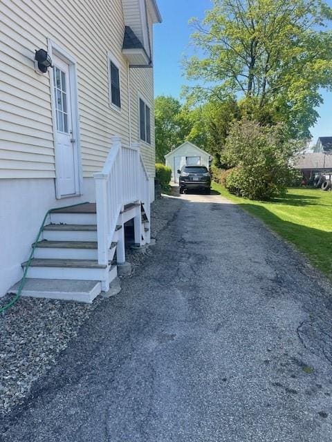 view of home's exterior featuring a yard and a garage