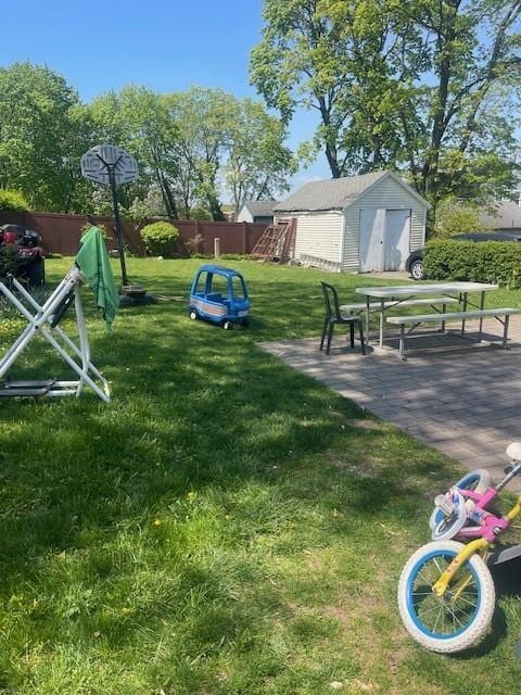 surrounding community with an outbuilding, a yard, and a patio area