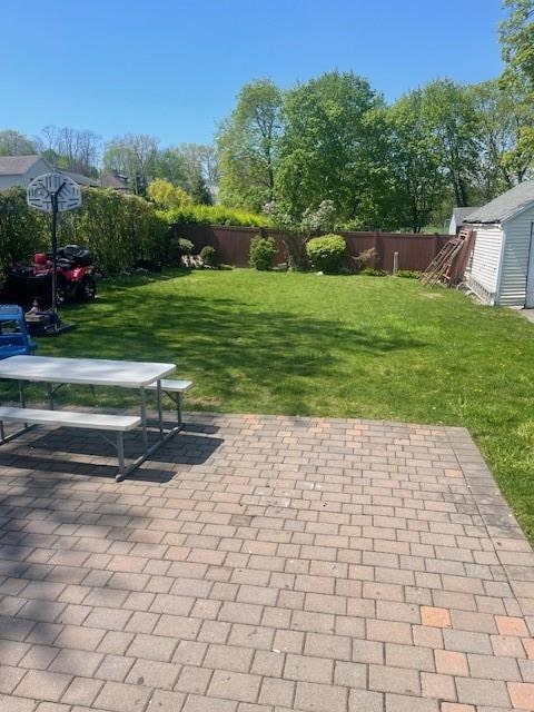 exterior space with a patio area and a lawn