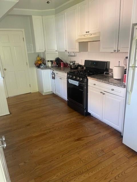 kitchen with gas stove, white cabinets, dark wood-type flooring, and white refrigerator