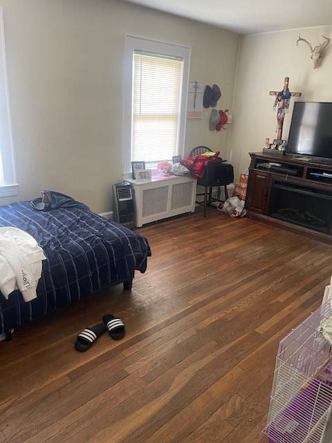 bedroom with dark wood-type flooring