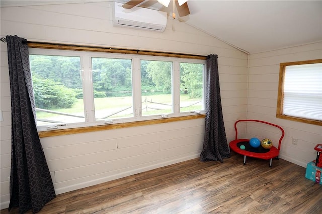 rec room featuring a wall unit AC, wood walls, dark hardwood / wood-style flooring, and lofted ceiling