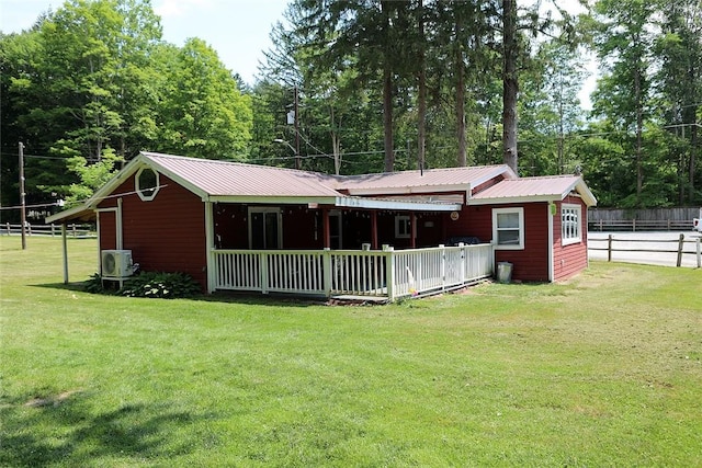 back of house featuring a yard and ac unit