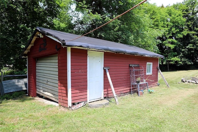 view of outbuilding featuring a lawn