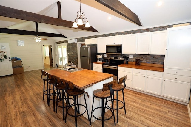 10 Ferry St, Fremont Center, NY 12736 - kitchen with stainless steel appliances, wood counters, a sink, white cabinets, and light wood-style flooring