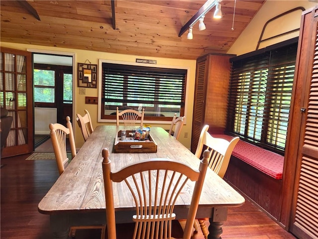 dining room featuring wooden ceiling, lofted ceiling with beams, dark wood-type flooring, and a healthy amount of sunlight