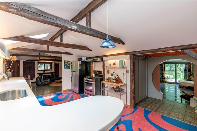 interior space featuring hardwood / wood-style floors, vaulted ceiling with beams, and sink