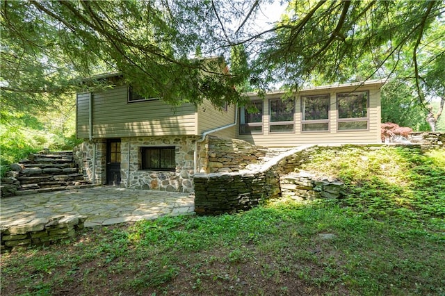 rear view of property featuring a patio