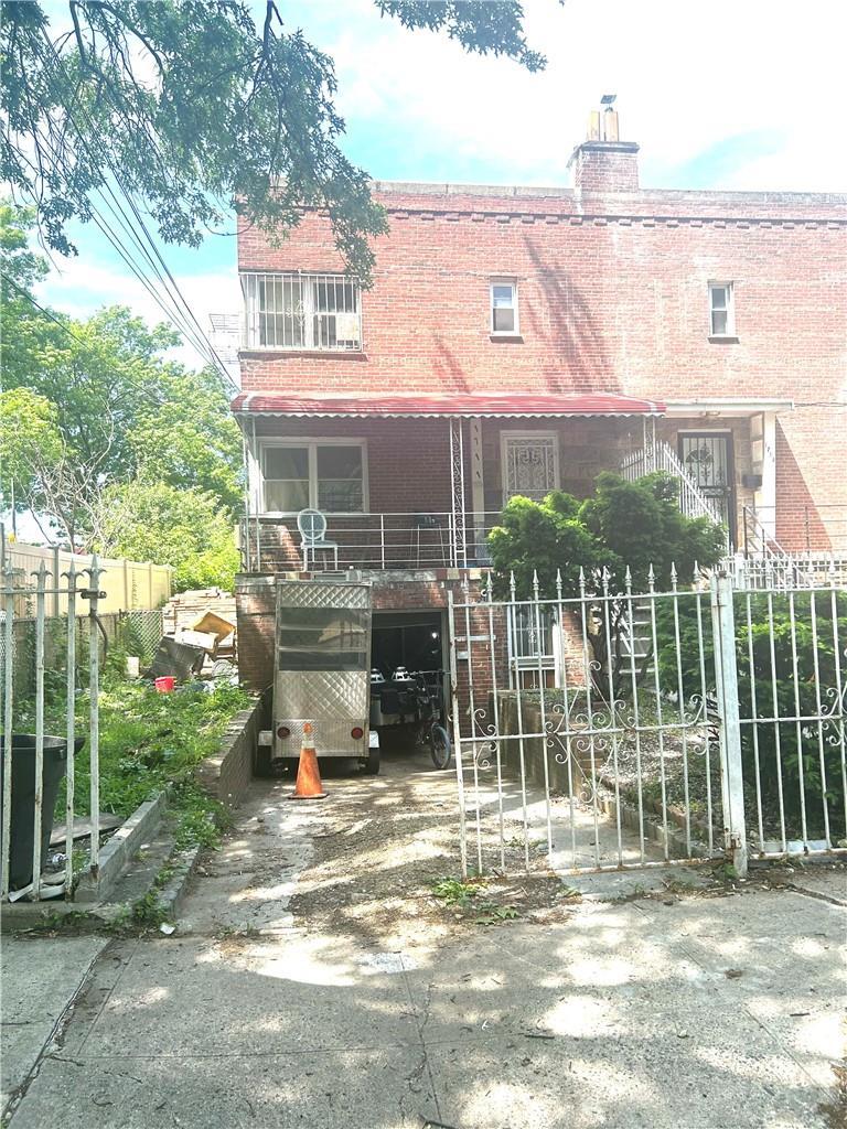 1711 Mansion St, Bronx, NY 10460 - view of front of home with brick siding and a chimney