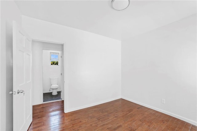 unfurnished room with dark hardwood / wood-style floors