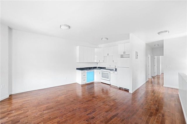 kitchen featuring white appliances, dark hardwood / wood-style floors, white cabinetry, and sink