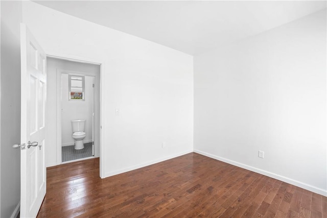 unfurnished room with dark hardwood / wood-style flooring