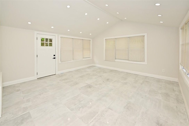 empty room featuring lofted ceiling