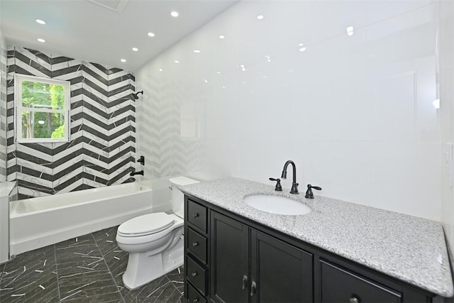 full bathroom with vanity, toilet, and tiled shower / bath