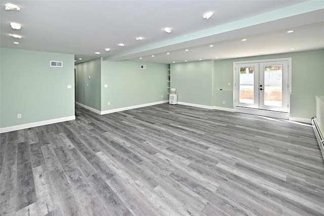 unfurnished living room with french doors and hardwood / wood-style flooring