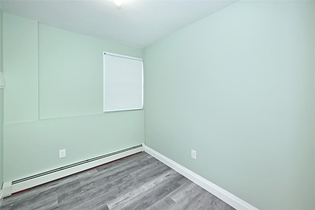 empty room featuring light hardwood / wood-style flooring and a baseboard radiator