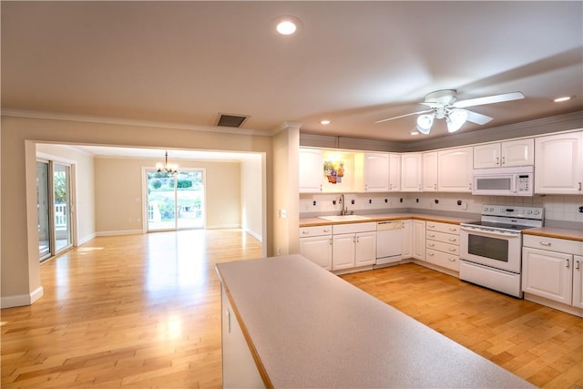 kitchen featuring white cabinets, white appliances, light hardwood / wood-style floors, and sink