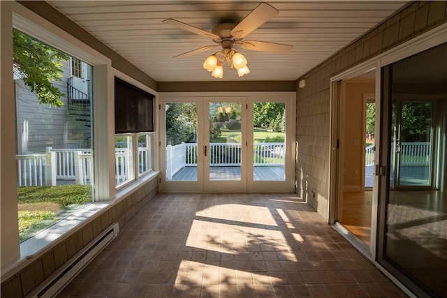 unfurnished sunroom with ceiling fan, french doors, and a baseboard heating unit