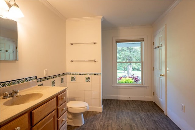 bathroom with vanity, crown molding, toilet, tile walls, and wood-type flooring