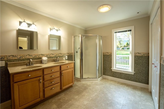 bathroom featuring vanity, a shower with door, tile walls, and ornamental molding