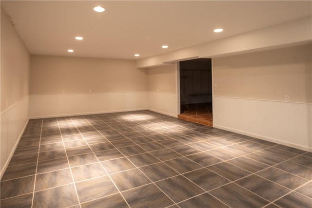 spare room featuring dark tile patterned floors