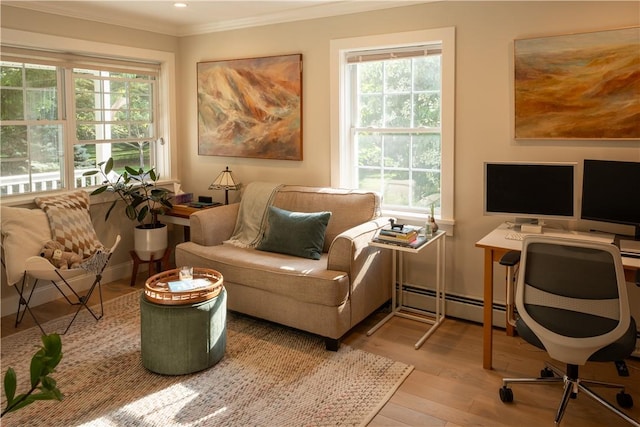 interior space featuring plenty of natural light, a baseboard heating unit, and light wood-type flooring