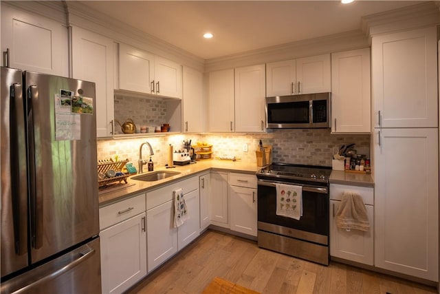 kitchen with white cabinetry, sink, and stainless steel appliances