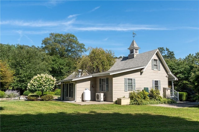 back of house with a yard and ac unit