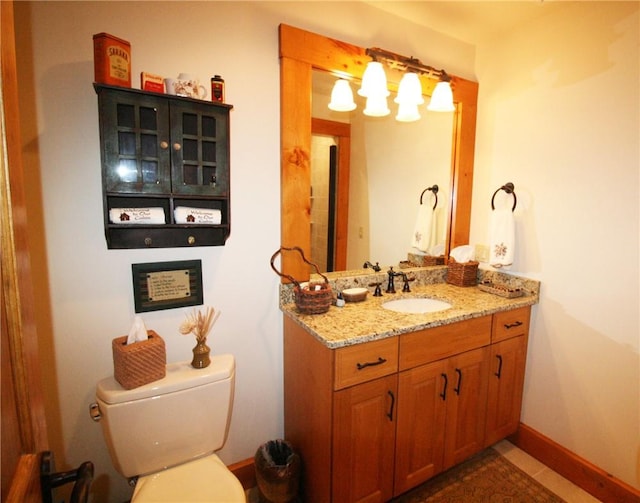 bathroom featuring tile patterned floors, vanity, and toilet